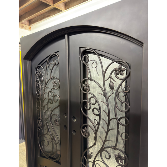 Decorative metal door with intricate designs in a workshop setting