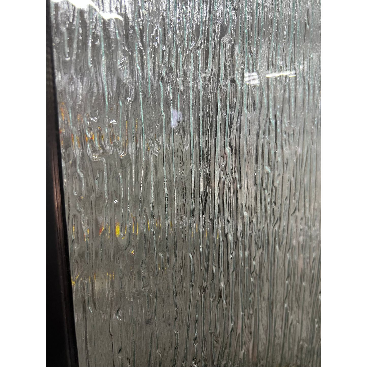 Black metal door with glass panels and decorative ironwork