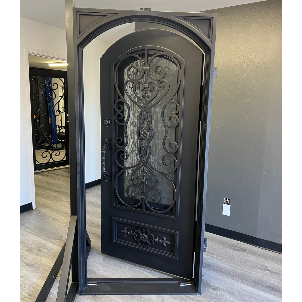 Decorative black door with intricate designs in a room setting