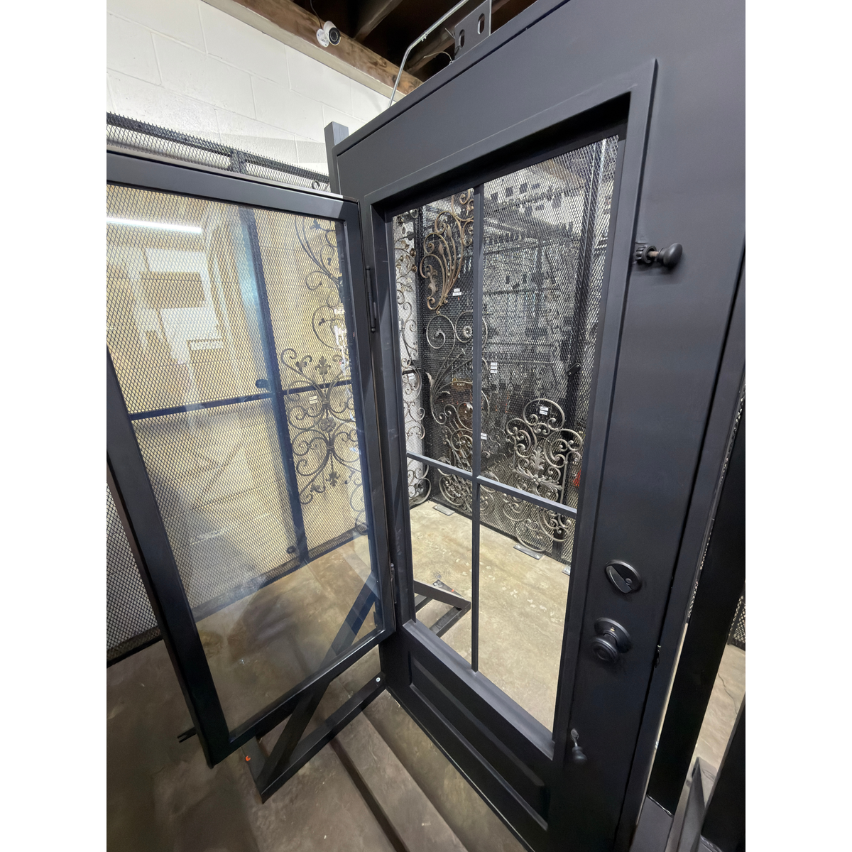 Glass door with a black handle, showing a clear glass window