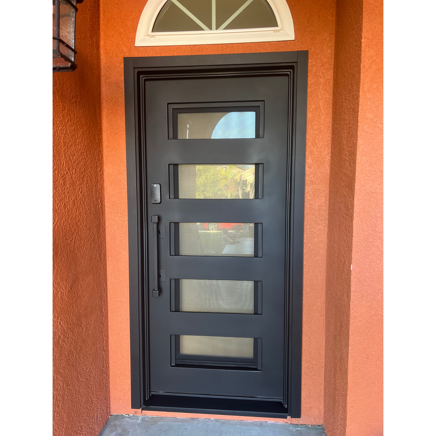 Black framed glass door on a red brick wall