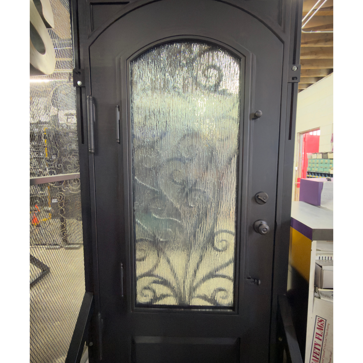 Decorative black door with glass panel in a store setting