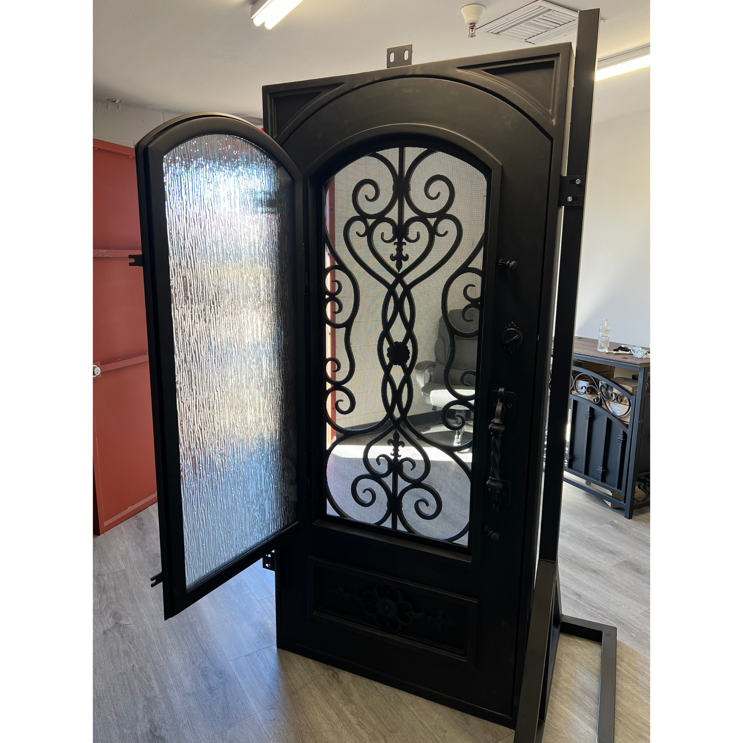 Decorative black metal door with glass panels in a room setting