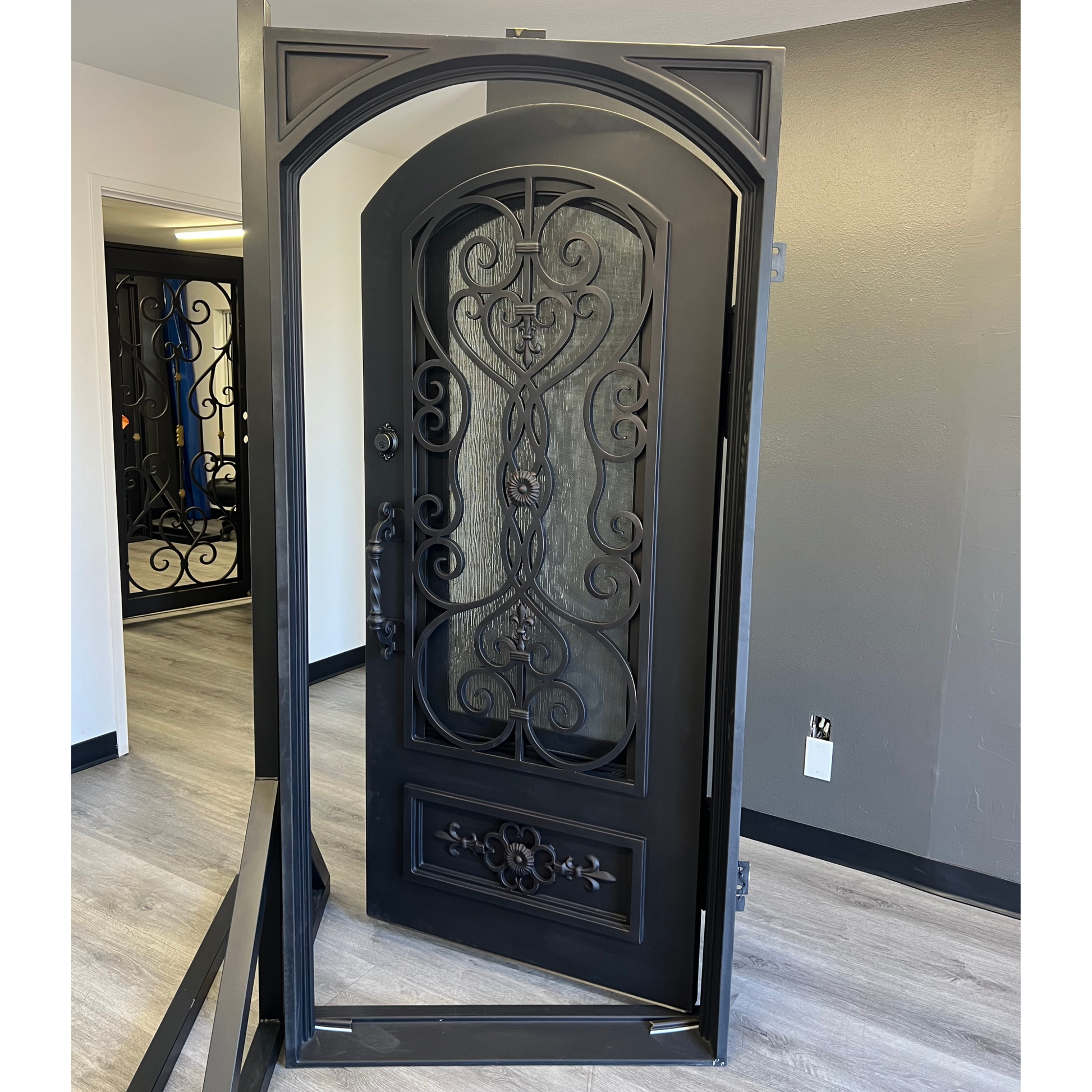 Decorative black door with intricate designs in a room setting