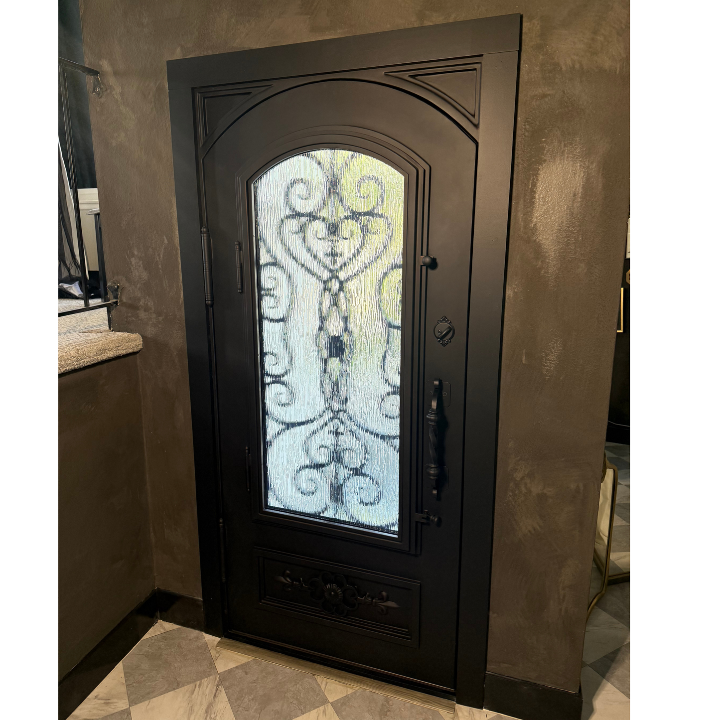 Decorative black door with stained glass panel in a room with beige walls and tiled floor.