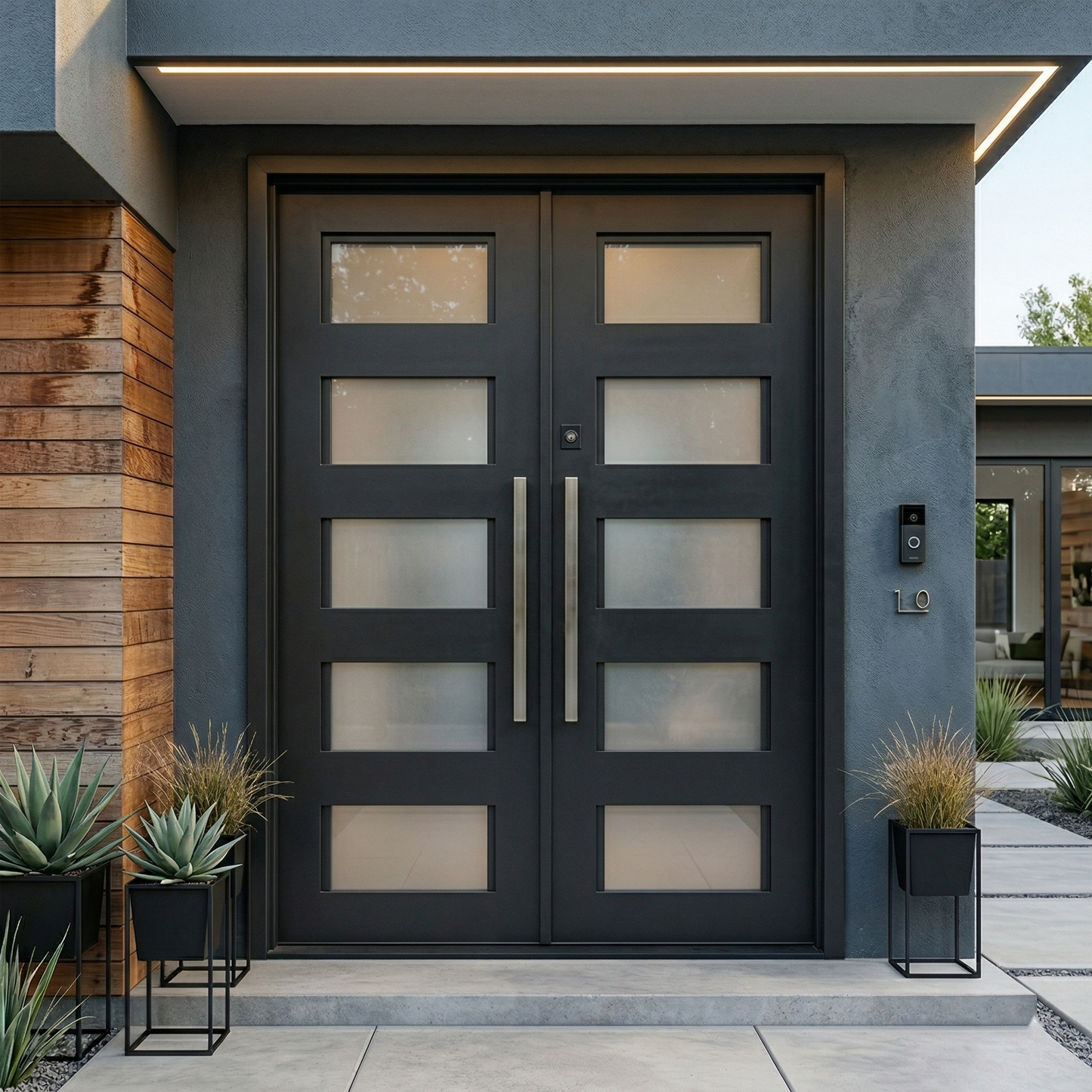Modern black double door entrance with decorative plants on a gray building exterior.