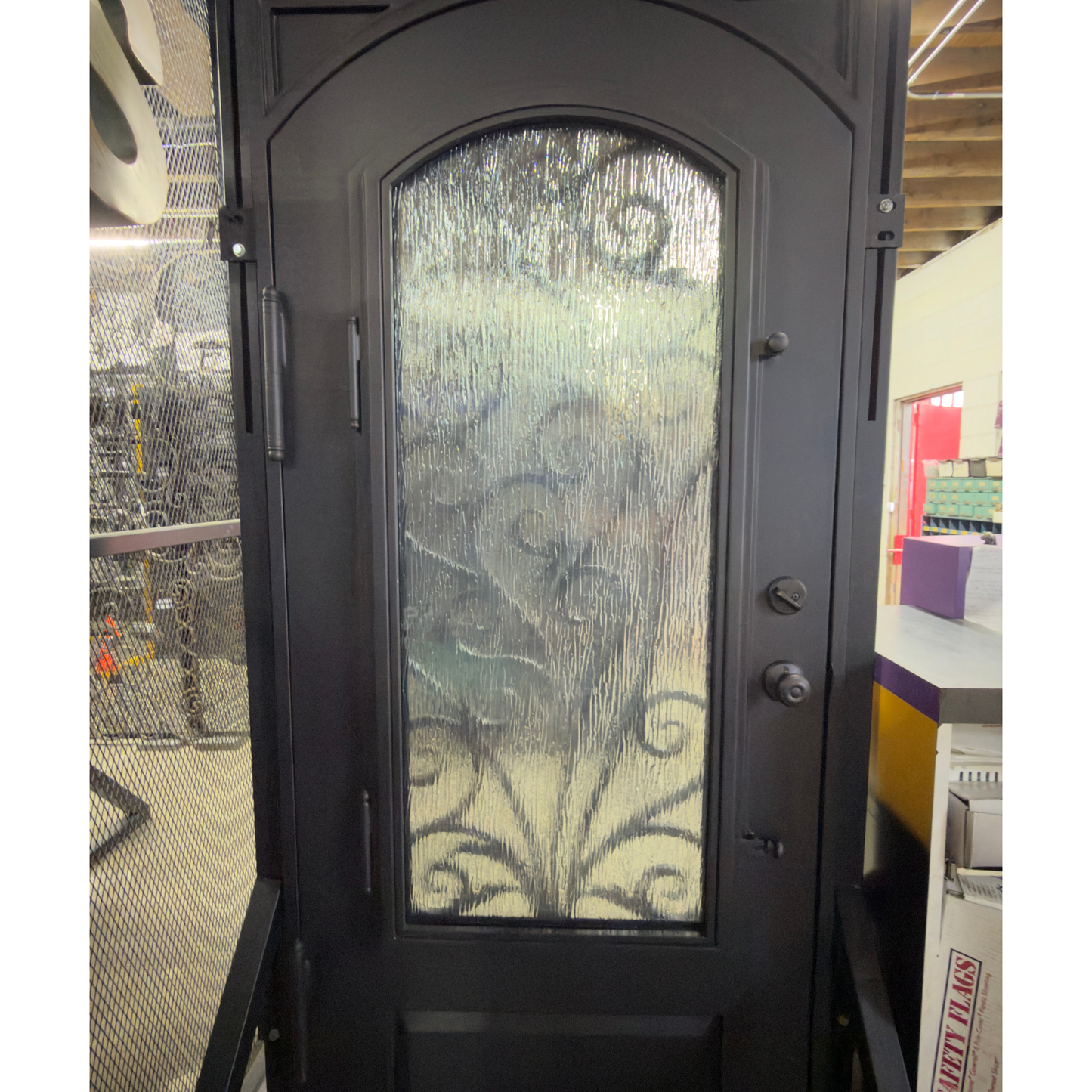 Decorative black door with glass panel in a store setting