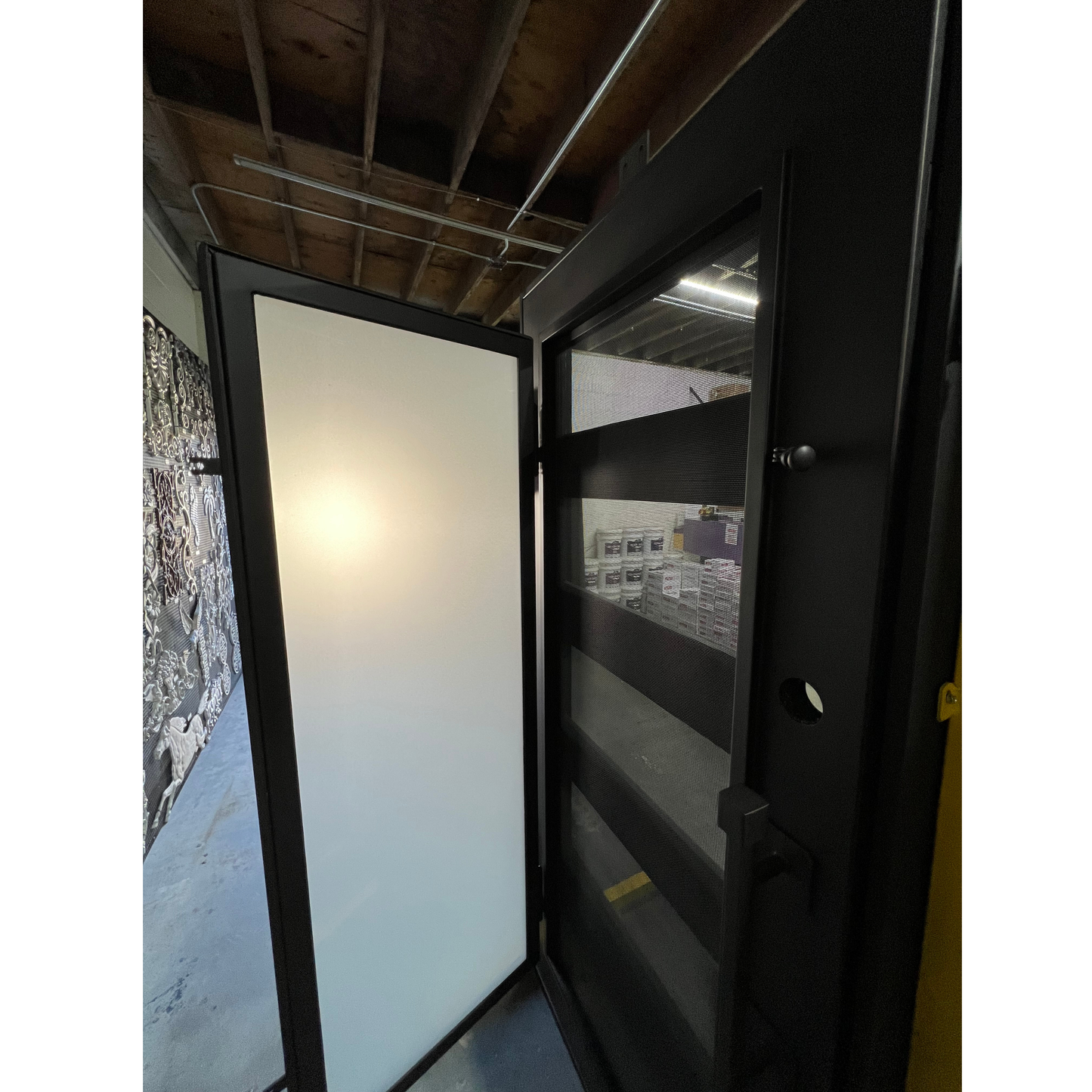 Glass door with a black frame in an indoor setting